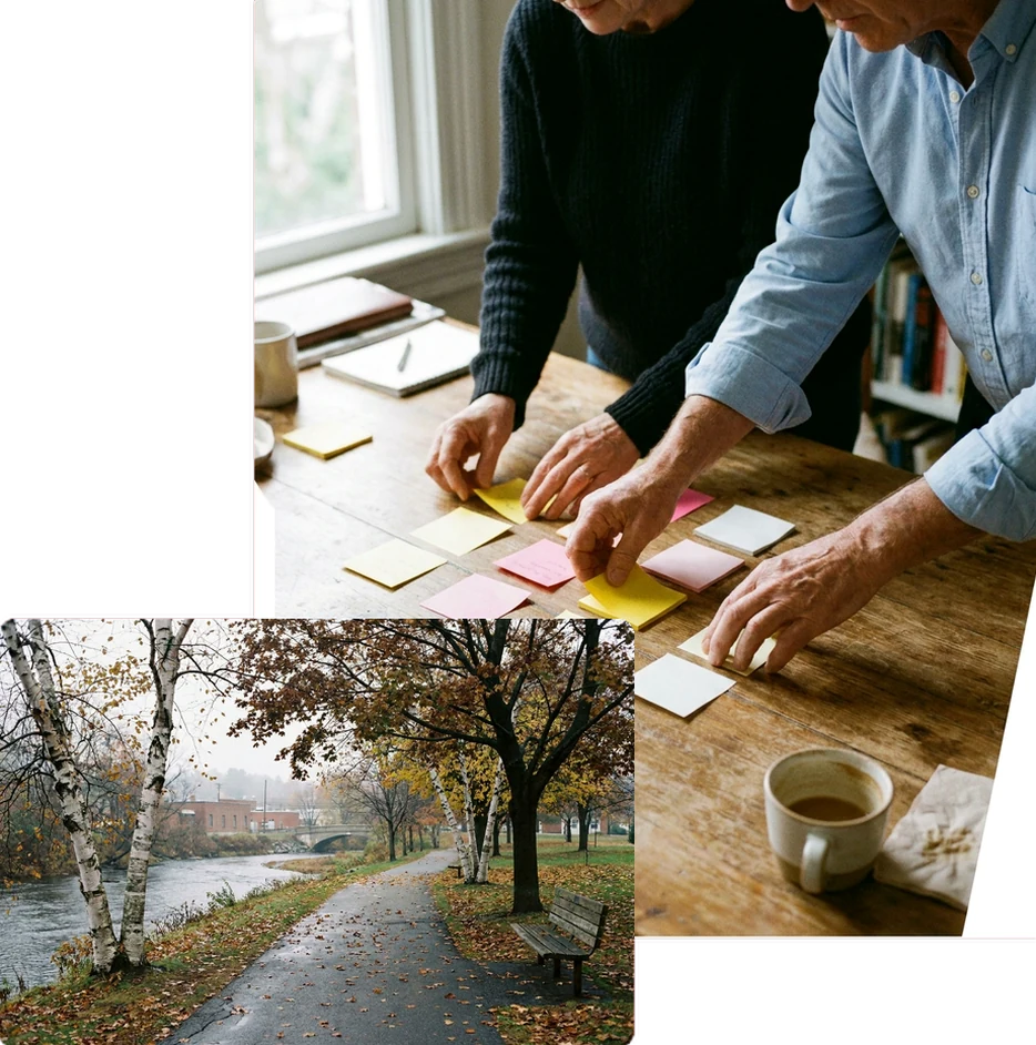 Two people arranging sticky notes into columns on a table.